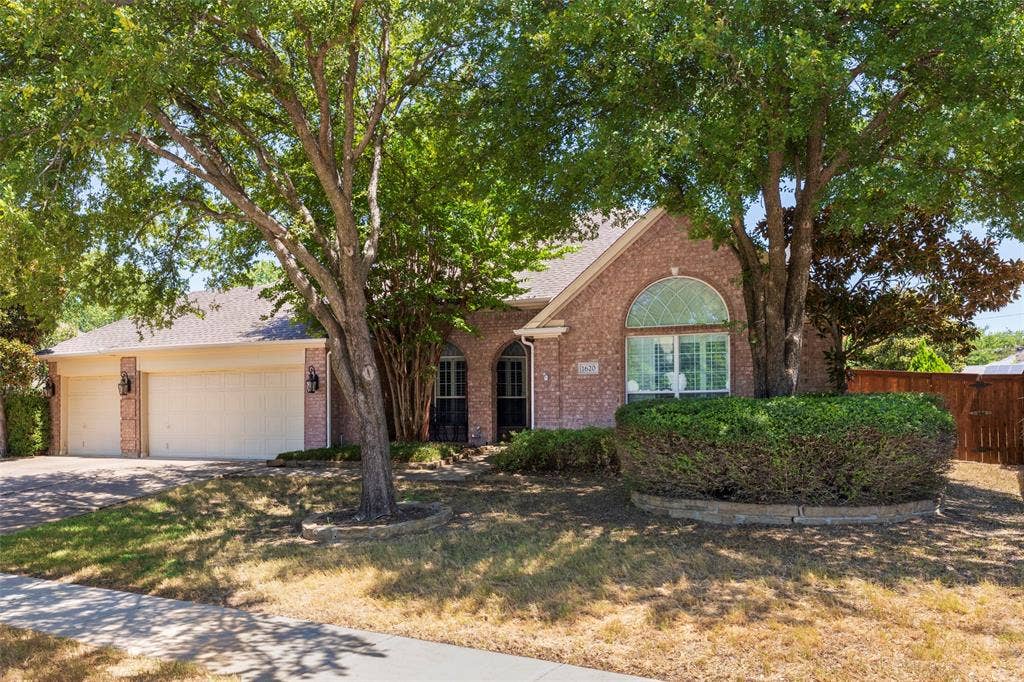 1620 Babbling Brook Drive, Grand Prairie, TX 75050 Brick exterior with a gabled roof and arched window detailing