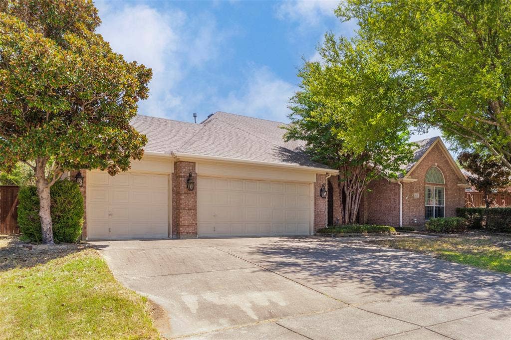 1620 Babbling Brook Drive, Grand Prairie, TX 75050 Brick exterior with a gabled roofline, arched window, and a multi-car garage