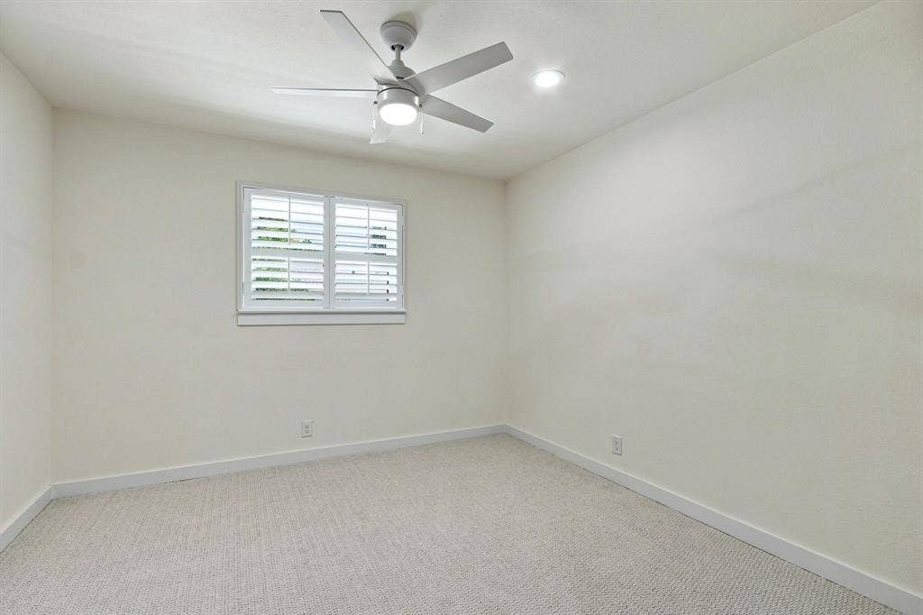 1409 Navaho Trail, Richardson, TX 75080 Recessed lighting, window with plantation shutters, ceiling fan with integrated light, and neutral wall paint