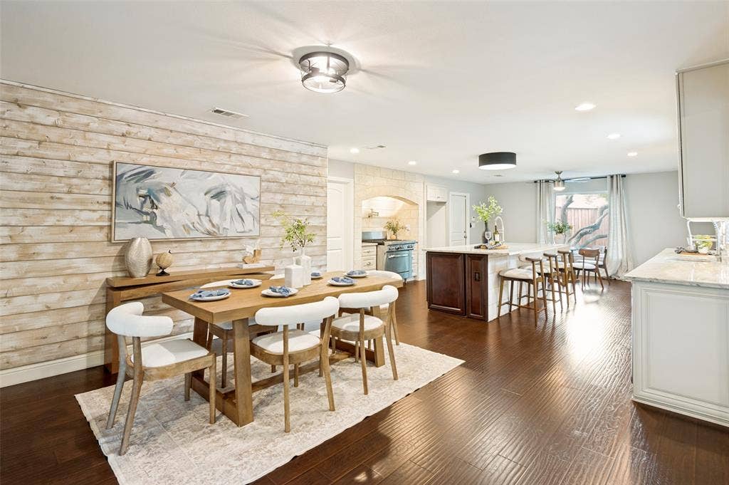 The dining room is centrally located between the kitchen and living area.