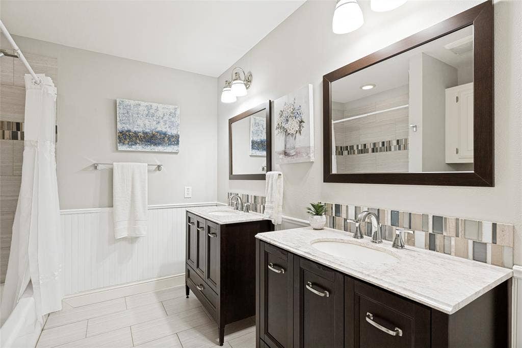 Large secondary bathroom with dual vanites.