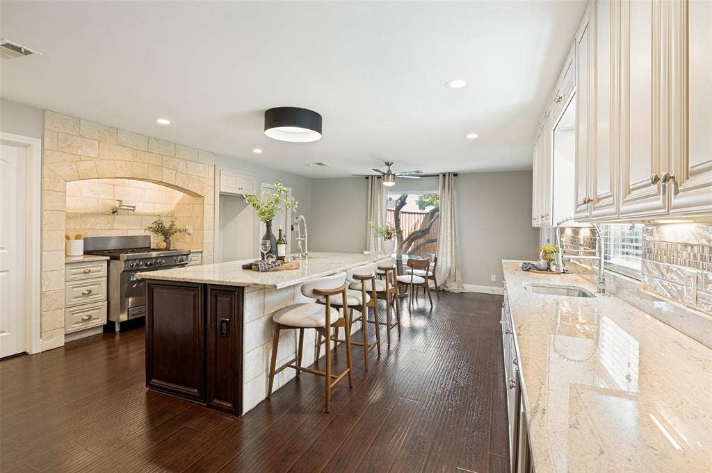 The large chef's kitchen with breakfast bar seating is the heart of the home.