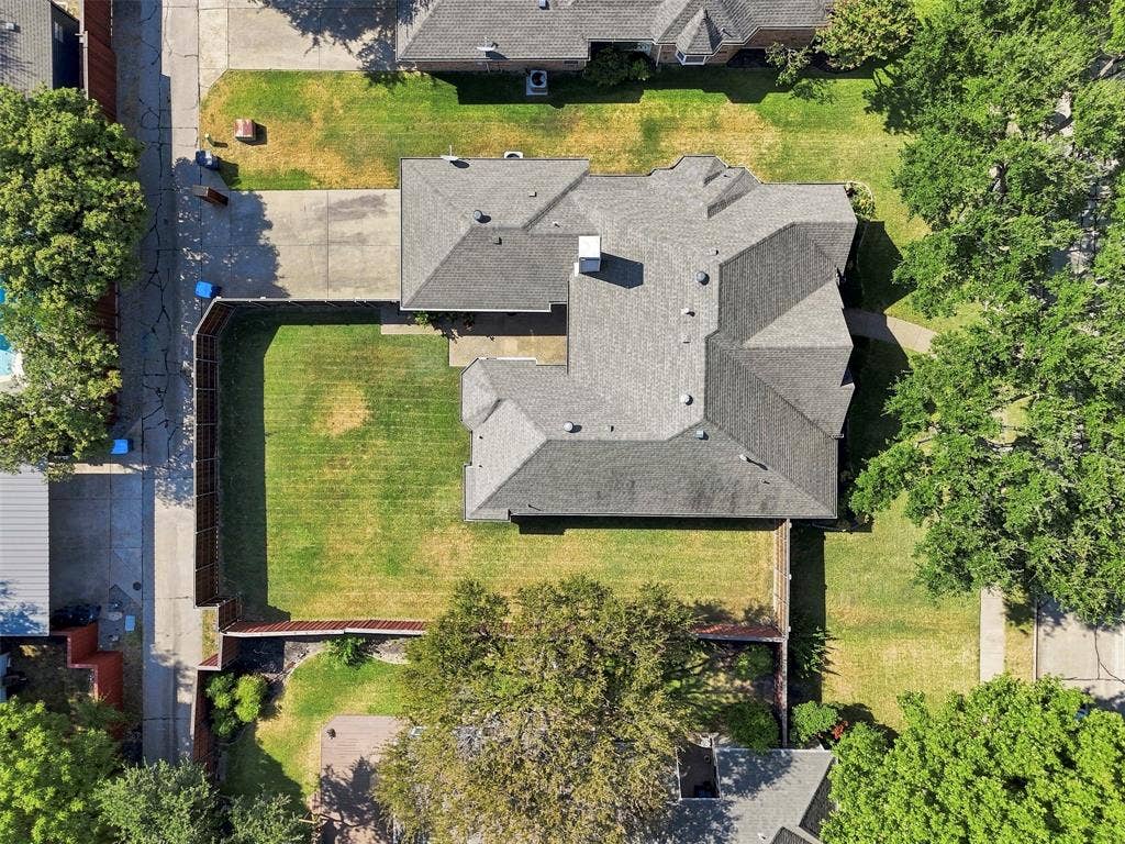2910 Live Oak Drive, Rowlett, TX 75088 Expansive property featuring a gabled roofline, substantial backyard, concrete driveway, and mature landscaping