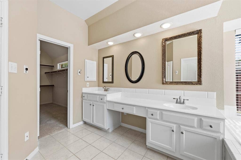 2910 Live Oak Drive, Rowlett, TX 75088 Dual sink vanity with white cabinetry, recessed lighting, and tiled flooring