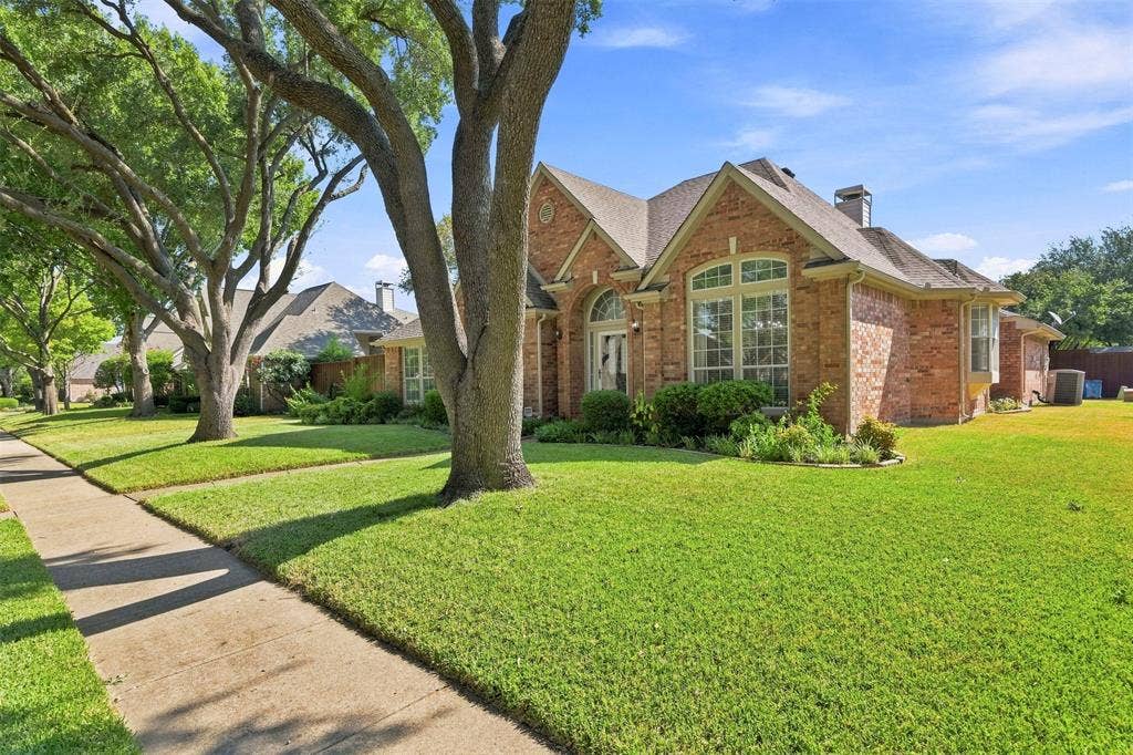 2910 Live Oak Drive, Rowlett, TX 75088 Brick exterior with multiple gables, arched entry, and bay window
