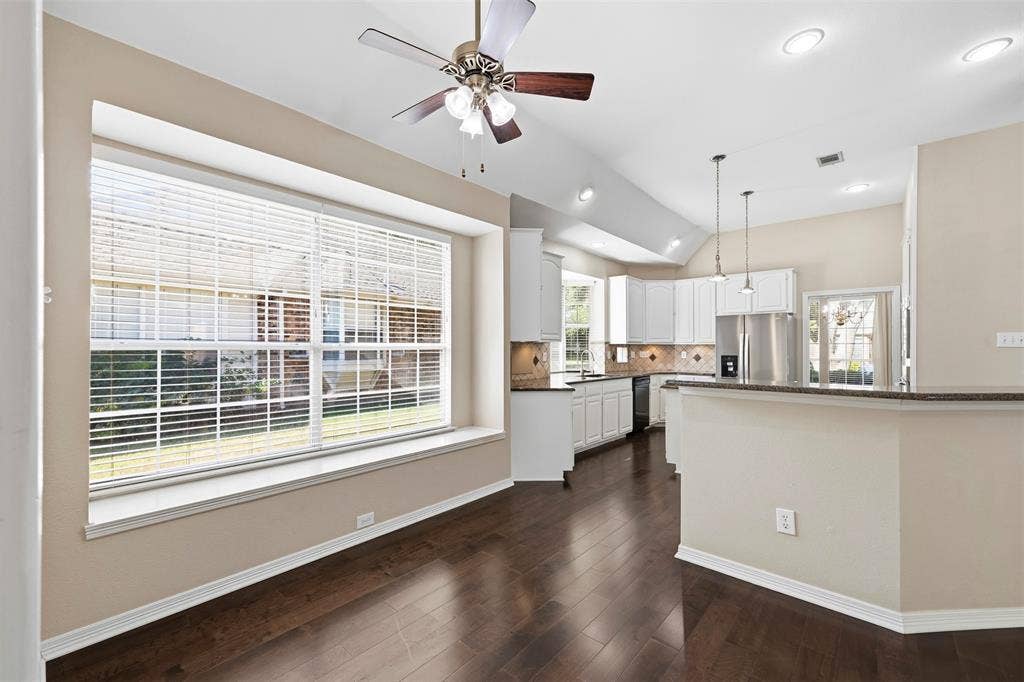 2910 Live Oak Drive, Rowlett, TX 75088 Vaulted ceilings, recessed lighting, and a ceiling fan enhance the open-concept design