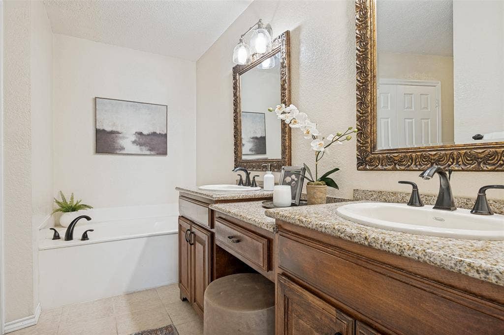 2922 Andrea Lane, Garland, TX 75040 Dual vanity with granite-style countertops, under-mount sinks, and oil-rubbed bronze fixtures