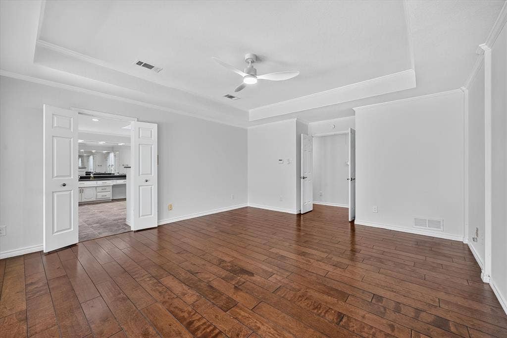 wood-finish flooring, large primary, panned ceiling