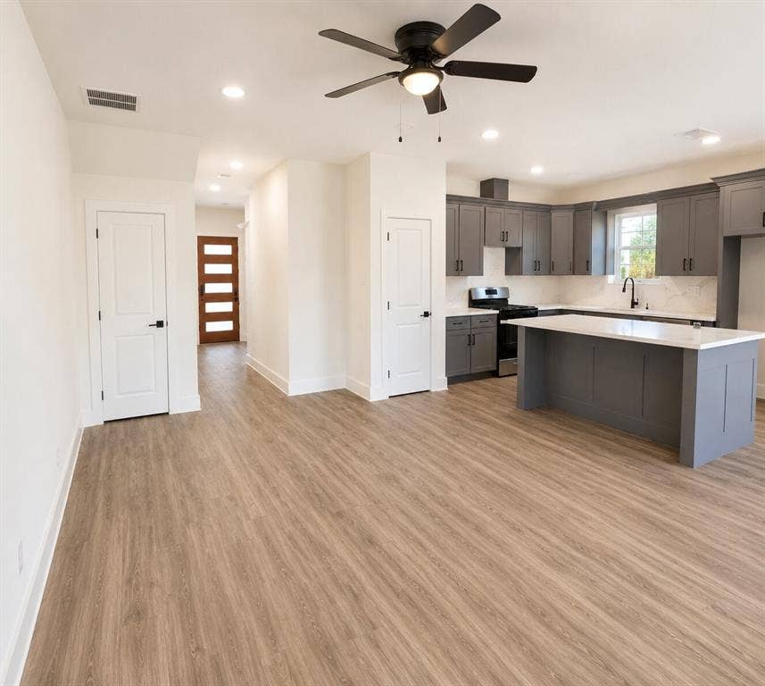 2542 Hooper Street, Dallas, TX 75215 Open-concept living area with wood-finish flooring, a modern ceiling fan, and recessed lighting