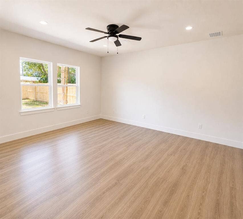 2542 Hooper Street, Dallas, TX 75215 Spacious interior featuring wood-finish flooring, recessed lighting, and a contemporary ceiling fan