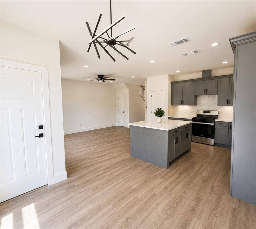 2542 Hooper Street, Dallas, TX 75215 Open-concept living space with wood-finish flooring, a modern chandelier, and recessed lighting