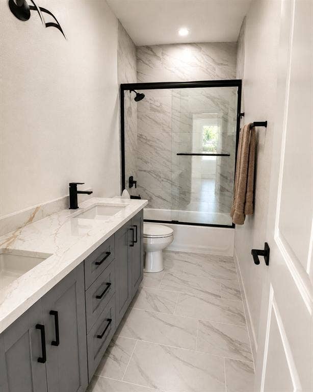 2542 Hooper Street, Dallas, TX 75215 Dual sink vanity with stone-finish countertop, matte black fixtures, and gray cabinetry