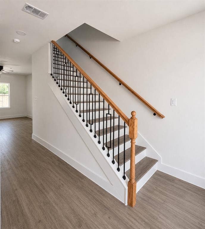 2542 Hooper Street, Dallas, TX 75215 Contemporary staircase with wood-finish treads, black metal balusters, and a natural wood handrail