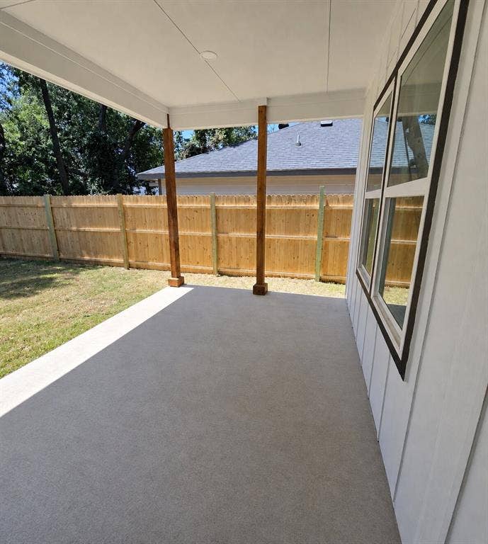 2542 Hooper Street, Dallas, TX 75215 Covered outdoor patio with a concrete surface, supported by two timber posts