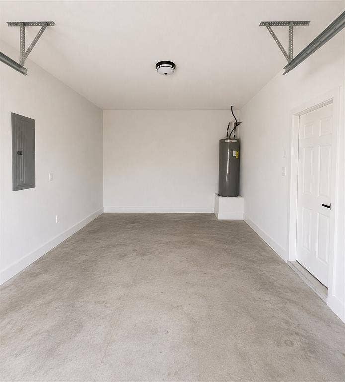 2542 Hooper Street, Dallas, TX 75215 Concrete flooring, white walls, flush mount ceiling light, utility door, and water heater