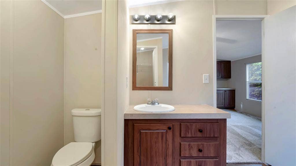 5390 Fm 314 S, Larue, TX 75770 Vanity with wood-finish cabinetry, integrated sink, and laminate countertop