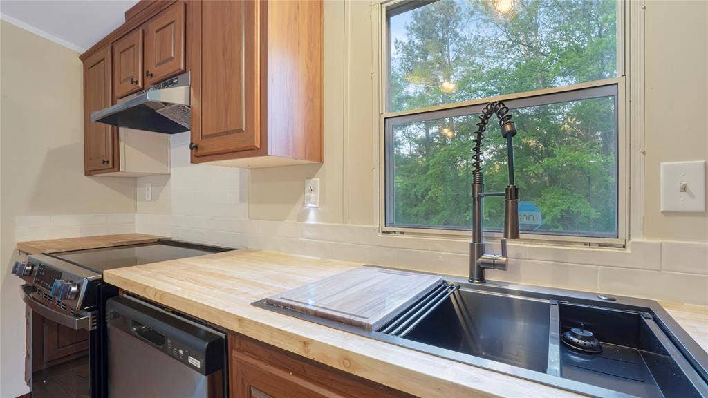 5390 Fm 314 S, Larue, TX 75770 Kitchen featuring wood-finish cabinetry, stainless steel appliances, butcher block countertops, and a subway tile backsplash