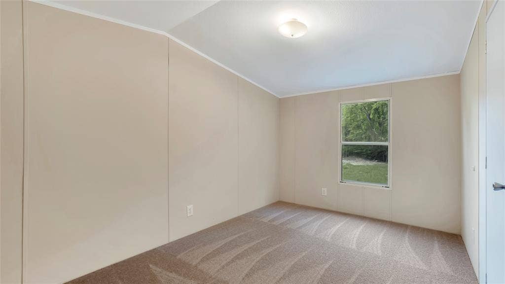 5390 Fm 314 S, Larue, TX 75770 Bright, light-filled bedroom with neutral wall finishes, wood-finish flooring, and a large window framing outdoor greenery