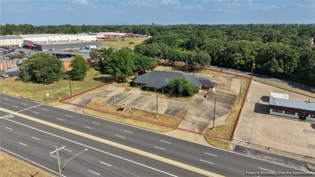 3210 W Northwest Loop 323, Tyler, TX 75702 Single-story commercial building with an asphalt shingle roof