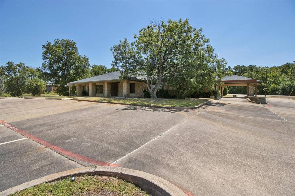 3210 W Northwest Loop 323, Tyler, TX 75702 Stone exterior building with a hip roof and multiple windows