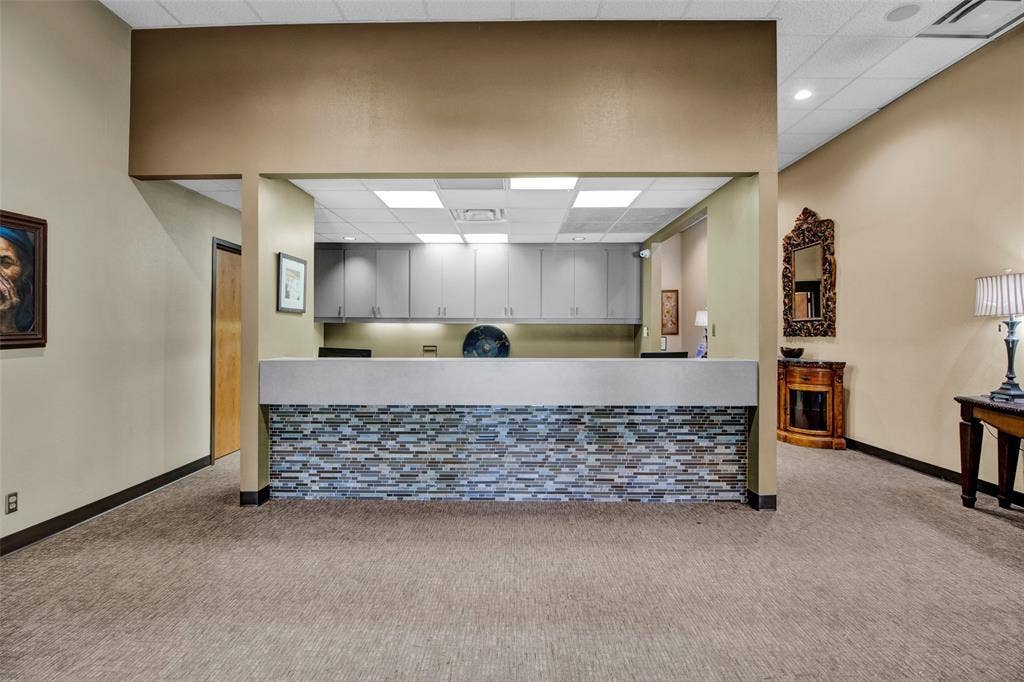 3210 W Northwest Loop 323, Tyler, TX 75702 Reception counter with a stacked stone facade, recessed lighting, and wall-mounted cabinetry
