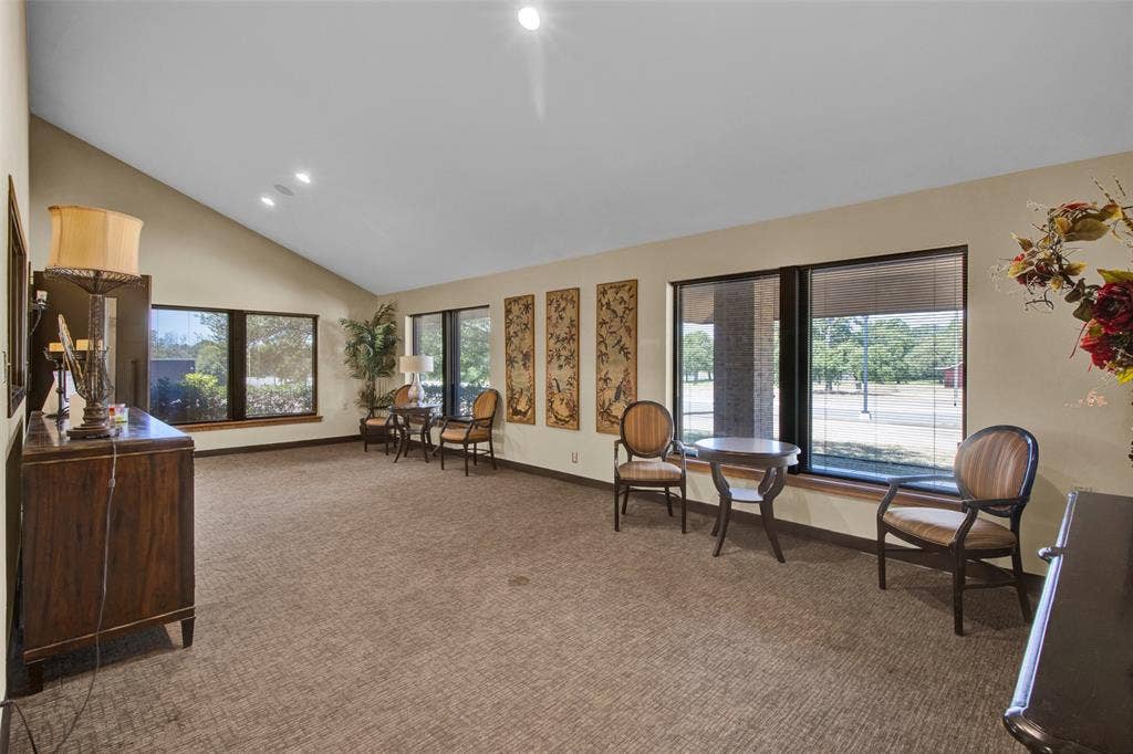 3210 W Northwest Loop 323, Tyler, TX 75702 Vaulted ceiling, recessed lighting, expansive windows, window sills, and textured carpeting
