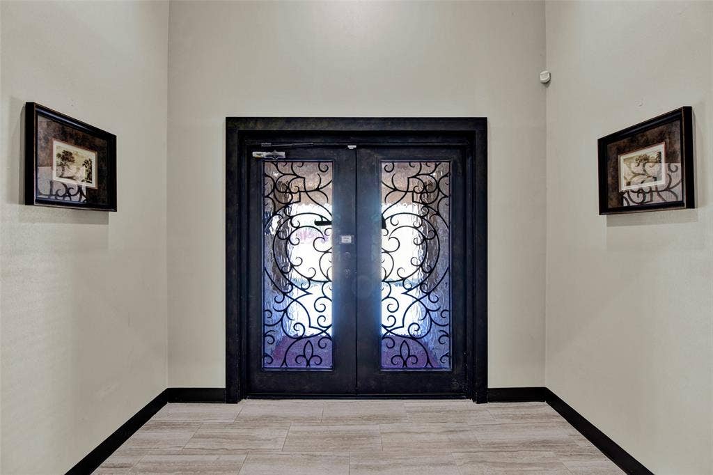 3210 W Northwest Loop 323, Tyler, TX 75702 Ornate double entry doors with decorative ironwork, framed by a dark trim