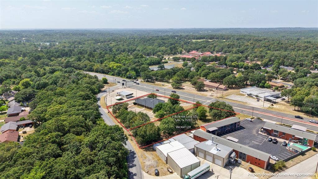 3210 W Northwest Loop 323, Tyler, TX 75702 Vacant lot with significant road frontage, surrounded by mature trees Opportunity to expand! Adjacent 1.01-acre commercial lot available SEPARATELY for $110,000. Lot is NOT included in the building’s listed price.