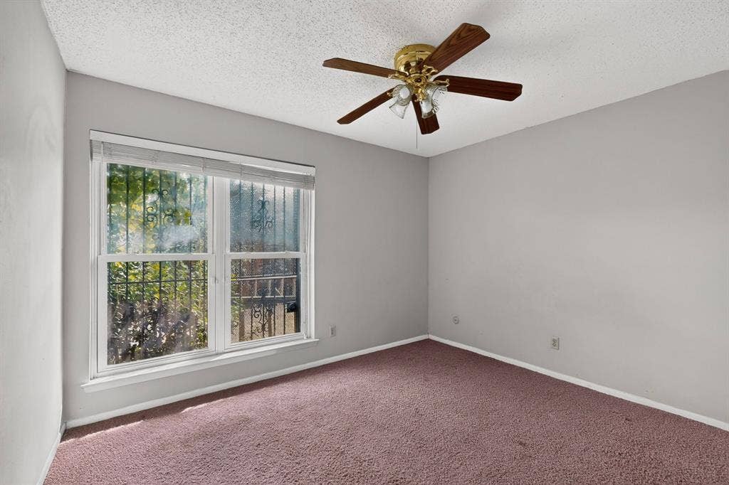 12502 Burninglog Lane, Dallas, TX 75243 Room featuring a ceiling fan with integrated lighting, a double window, and carpet flooring
