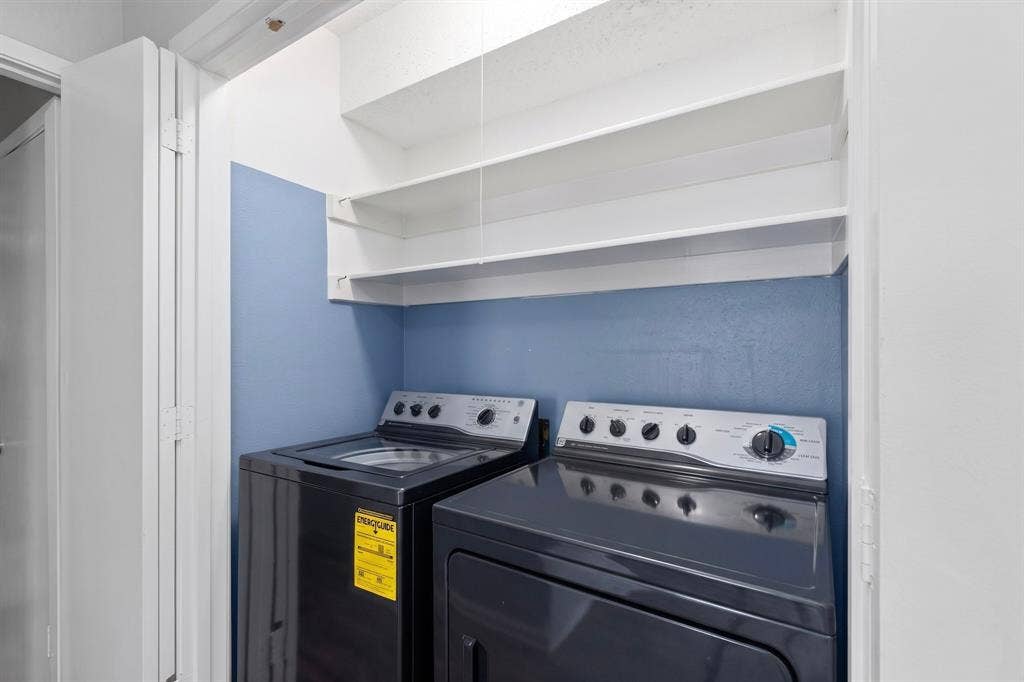 12502 Burninglog Lane, Dallas, TX 75243 Laundry area with built-in shelving and appliances