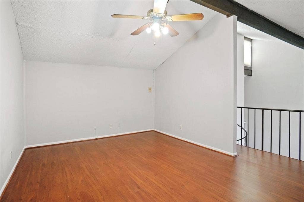 12502 Burninglog Lane, Dallas, TX 75243 Upstairs flex room; Vaulted ceiling with exposed beam, wood-finish flooring, and a ceiling fan