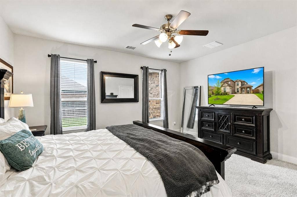 401 Llano Lane, Red Oak, TX 75154 Light-colored walls, wood-finish ceiling fan, and carpeted flooring