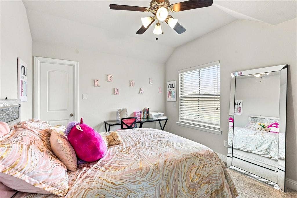 401 Llano Lane, Red Oak, TX 75154 Vaulted ceiling, ceiling fan with integrated lighting, window with horizontal blinds, neutral wall paint, and carpeted flooring