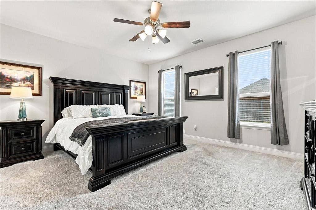 401 Llano Lane, Red Oak, TX 75154 Spacious room with a ceiling fan, light-toned carpeting, and multiple windows with blinds