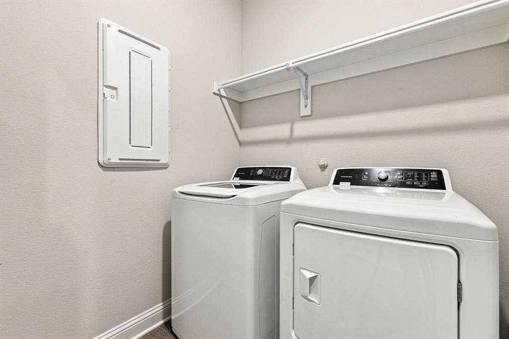 401 Llano Lane, Red Oak, TX 75154 Laundry area featuring a top-load washing machine and front-load dryer with a white wall-mounted shelf