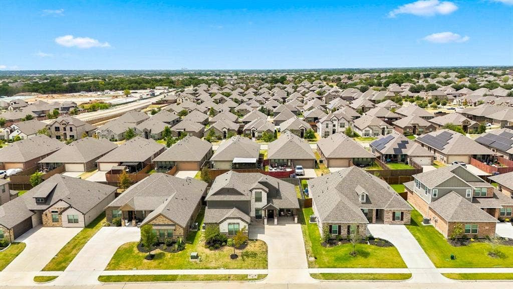 401 Llano Lane, Red Oak, TX 75154 Residential community featuring a variety of single-family homes with pitched roofs and attached garages