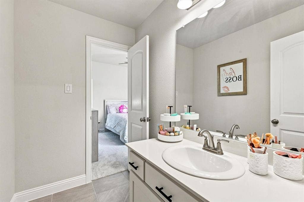 401 Llano Lane, Red Oak, TX 75154 Vanity with an integrated oval sink, white countertop, and brushed nickel faucet