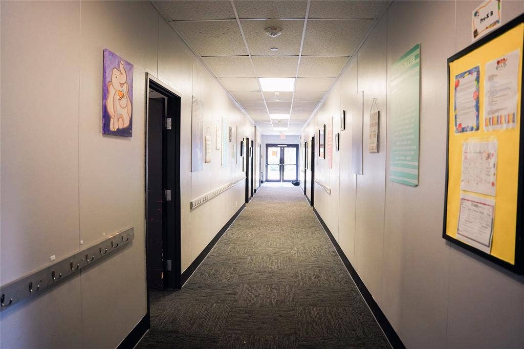 2705 Virginia Parkway, #SLE, McKinney, TX 75071 Long corridor featuring neutral walls