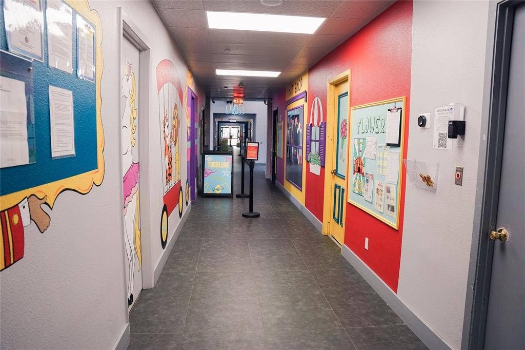 2705 Virginia Parkway, #SLE, McKinney, TX 75071 Hallway featuring vibrant wall murals, recessed lighting, and tile flooring