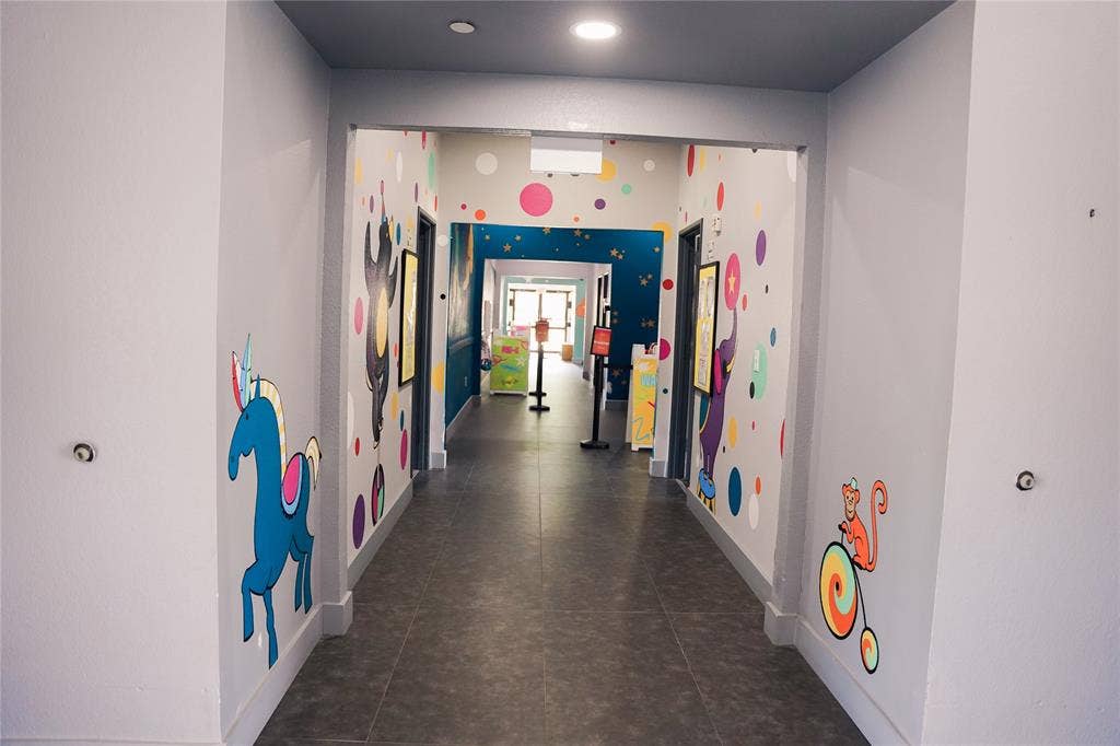 2705 Virginia Parkway, #SLE, McKinney, TX 75071 Hallway with grey flooring, recessed lighting, and colorful wall graphics