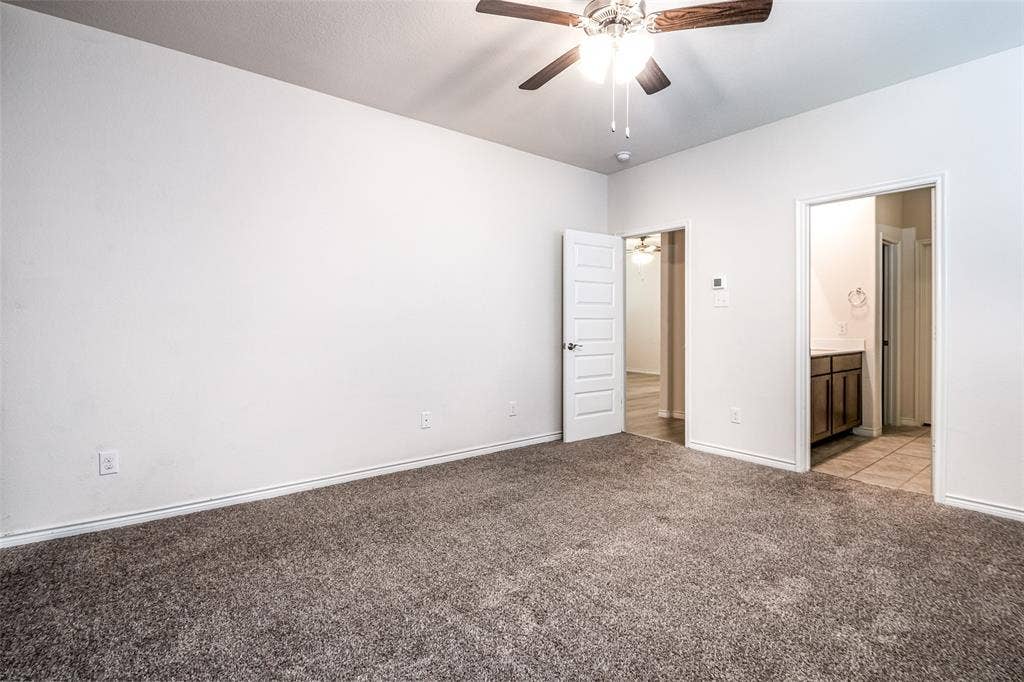 2721 Franklin Drive, Celina, TX 75009 Expansive room featuring plush carpeting, a ceiling fan with integrated lighting, and a five-panel interior door