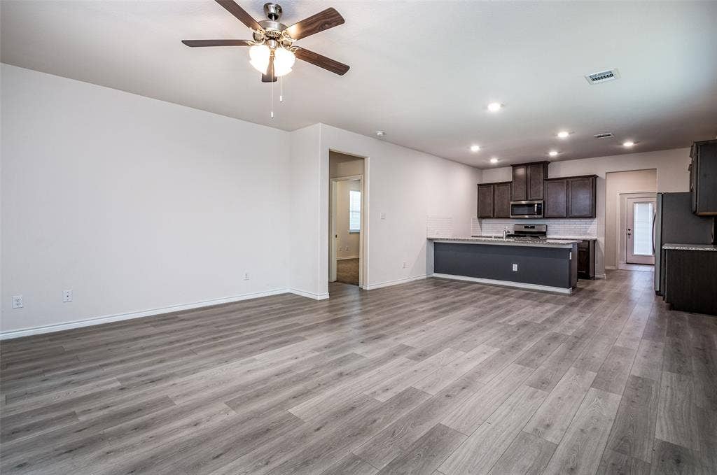 2721 Franklin Drive, Celina, TX 75009 Open-concept living space featuring wood-finish flooring, recessed lighting, and a ceiling fan