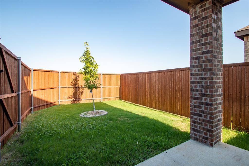 2721 Franklin Drive, Celina, TX 75009 Private backyard with wood fencing, a young tree, and a concrete patio