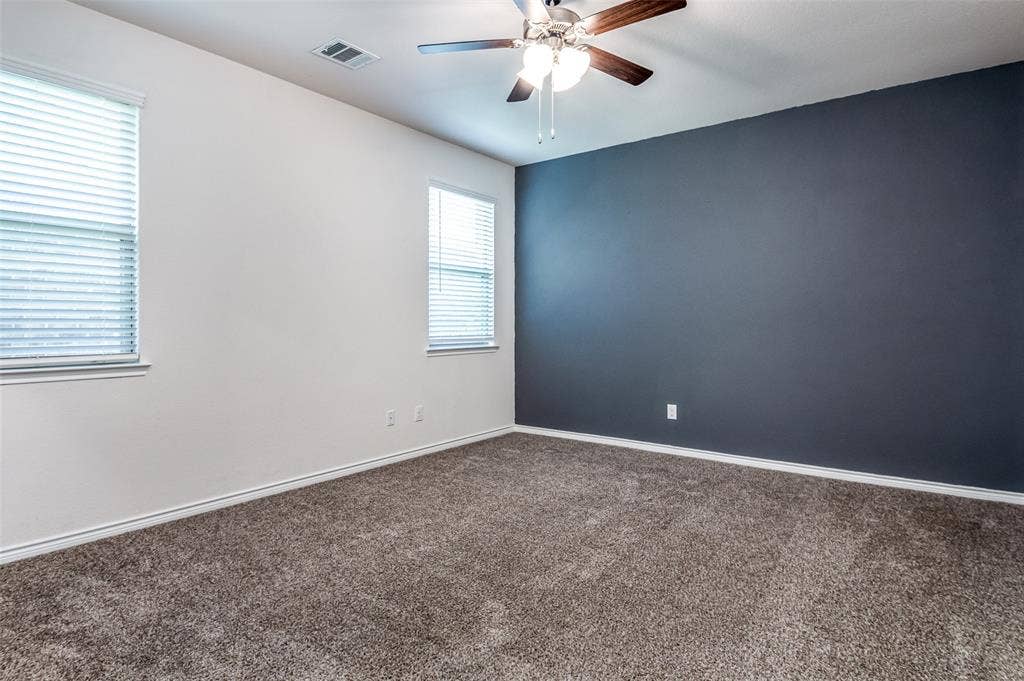 2721 Franklin Drive, Celina, TX 75009 Carpeted flooring, two windows with blinds, ceiling fan with light fixture, white and accent wall finishes