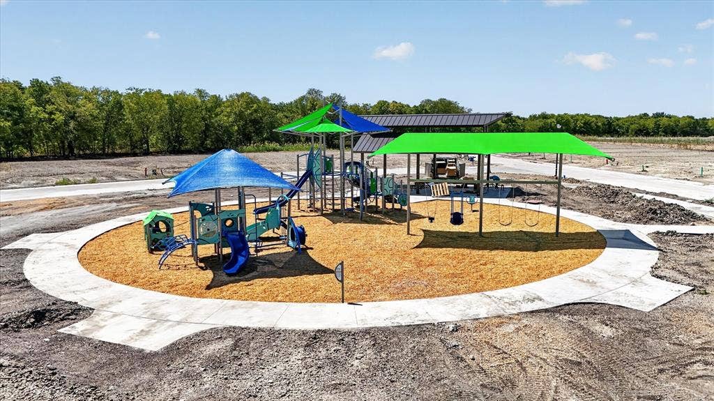 5308 Tupper Avenue, Fate, TX 75087 Recreational area featuring a playground with slides, multiple swings, and protective shade structures