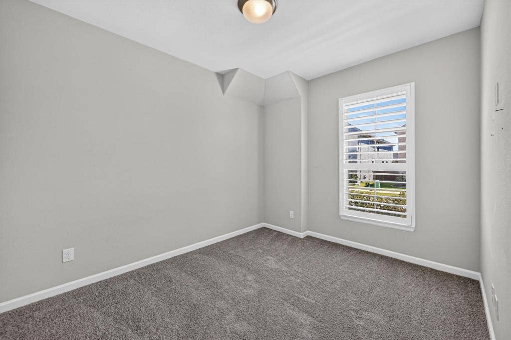 5308 Tupper Avenue, Fate, TX 75087 Neutral wall color, window with horizontal blinds, overhead flush mount light fixture, and carpet flooring
