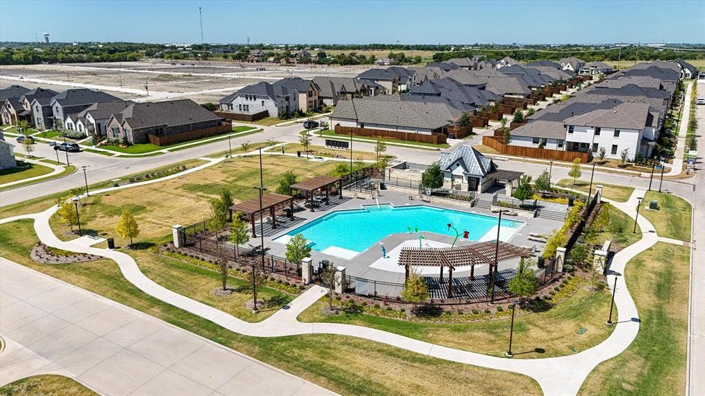 5308 Tupper Avenue, Fate, TX 75087 Community swimming pool with sun shelf, adjacent pool deck with pergolas, and a separate splash pad