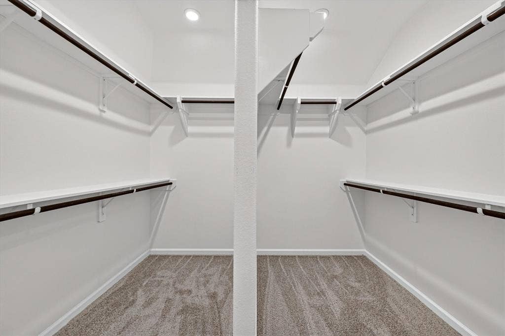 5308 Tupper Avenue, Fate, TX 75087 Recessed lighting illuminating a walk-in closet featuring built-in shelving, hanging rods, and carpeting