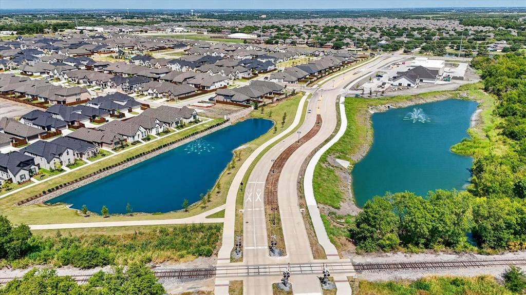 5308 Tupper Avenue, Fate, TX 75087 Newly developed residential area featuring multiple ponds, a water feature, and established roads