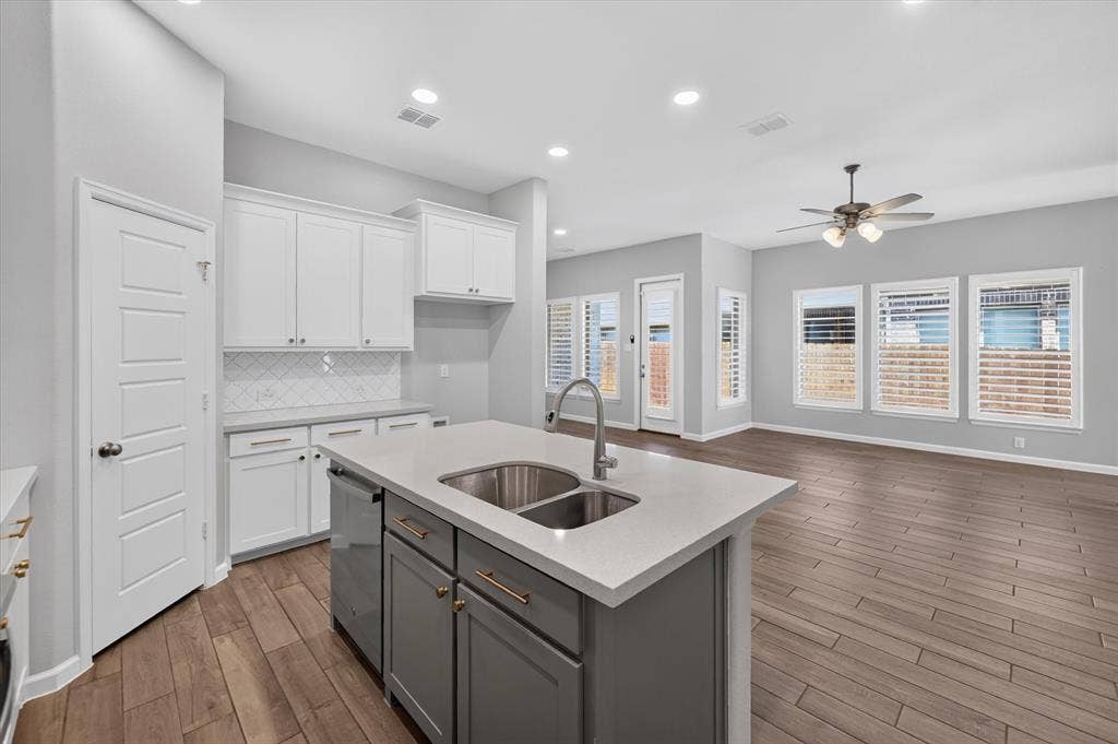 5308 Tupper Avenue, Fate, TX 75087 Kitchen island with dual stainless steel sinks and a chrome faucet